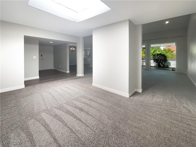 carpeted empty room with baseboards and recessed lighting