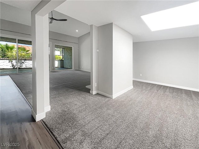empty room featuring baseboards and carpet flooring