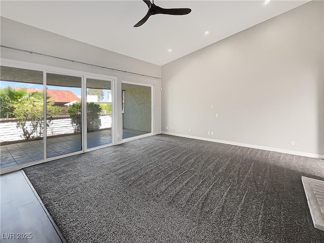 empty room featuring ceiling fan, lofted ceiling, dark colored carpet, baseboards, and recessed lighting