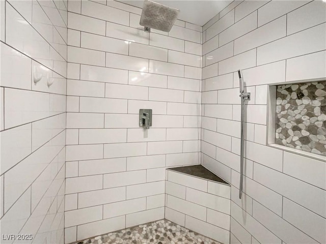 bathroom with tiled shower