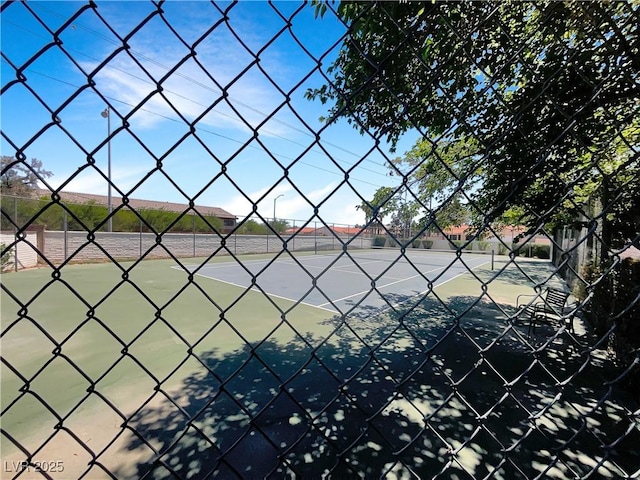 view of tennis court with fence