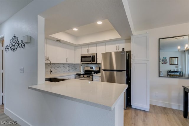 718 Nectarine Ct, Henderson, NV 89014 - kitchen featuring stainless steel appliances, light wood-style flooring, light countertops, and recessed lighting