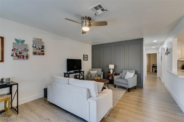 718 Nectarine Ct, Henderson, NV 89014 - living area with light wood-style flooring, a ceiling fan, and baseboards