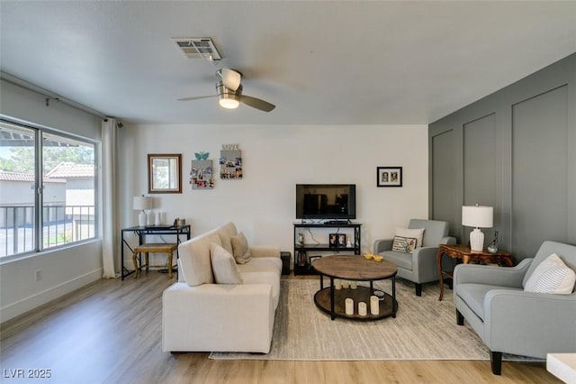 718 Nectarine Ct, Henderson, NV 89014 - living area with light wood finished floors, ceiling fan, and baseboards