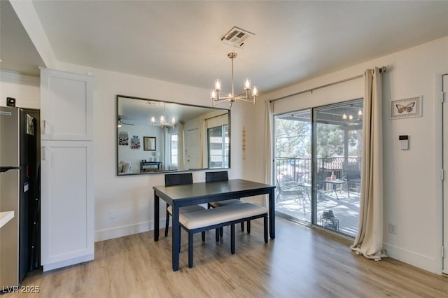 718 Nectarine Ct, Henderson, NV 89014 - dining area featuring a chandelier, light wood-type flooring, and baseboards