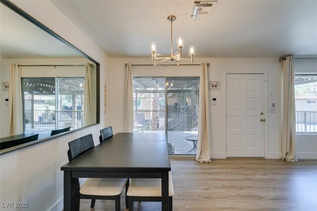 718 Nectarine Ct, Henderson, NV 89014 - dining space with a chandelier, light wood-type flooring, and baseboards
