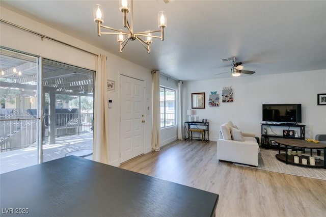 718 Nectarine Ct, Henderson, NV 89014 - living area with a chandelier, light wood-type flooring, a ceiling fan, and baseboards