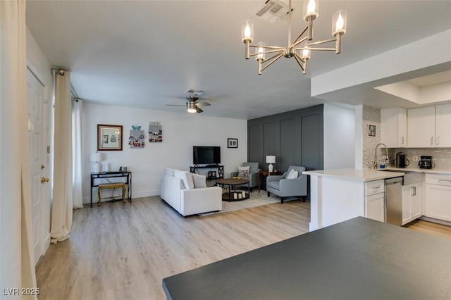 718 Nectarine Ct, Henderson, NV 89014 - living area featuring light wood-style flooring, a chandelier, ceiling fan, and baseboards