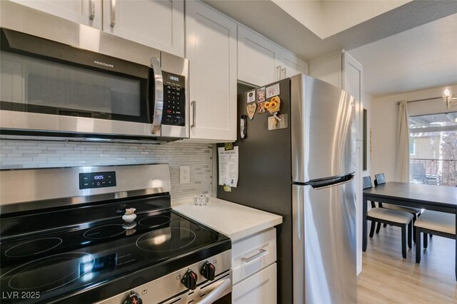718 Nectarine Ct, Henderson, NV 89014 - kitchen with appliances with stainless steel finishes, tasteful backsplash, white cabinetry, and light countertops