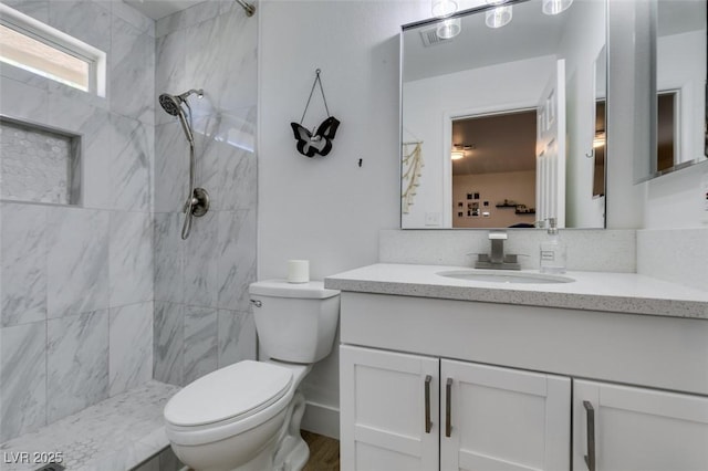 718 Nectarine Ct, Henderson, NV 89014 - bathroom featuring toilet, tiled shower, and vanity