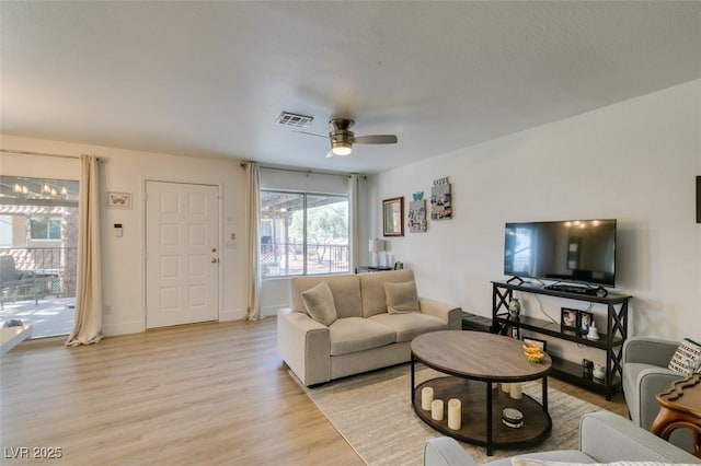 718 Nectarine Ct, Henderson, NV 89014 - living area with light wood finished floors, a ceiling fan, and baseboards