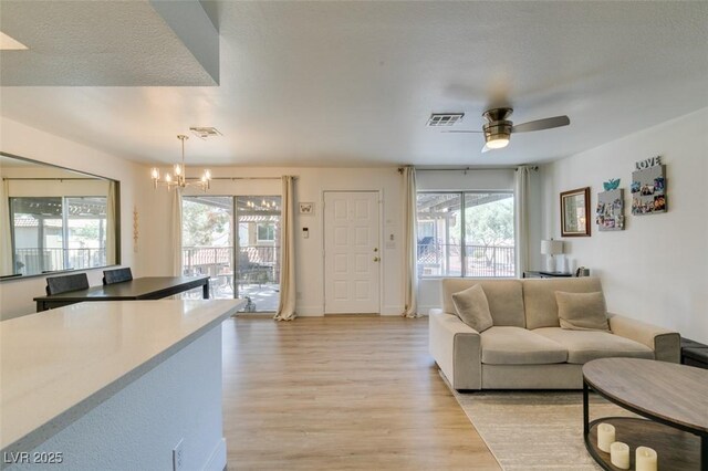 718 Nectarine Ct, Henderson, NV 89014 - living room featuring light wood-type flooring, a chandelier, and ceiling fan