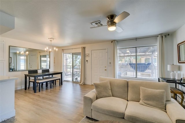 718 Nectarine Ct, Henderson, NV 89014 - living area with a chandelier, light wood-style floors, ceiling fan, and baseboards