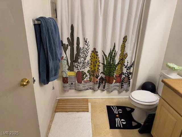 8250 N Grand Canyon Dr Unit 2154, Las Vegas, NV 89166 - bathroom featuring toilet, vanity, shower / tub combo, and baseboards