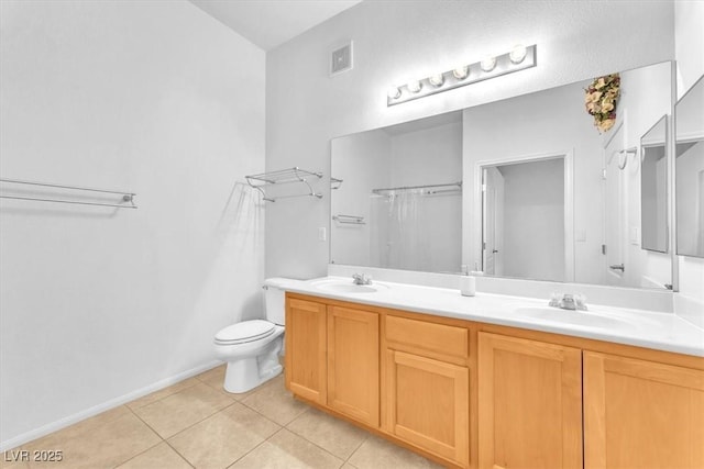 8985 S Durango Dr Unit 1110, Las Vegas, NV 89113 - full bathroom with tile patterned floors, toilet, double vanity, and baseboards