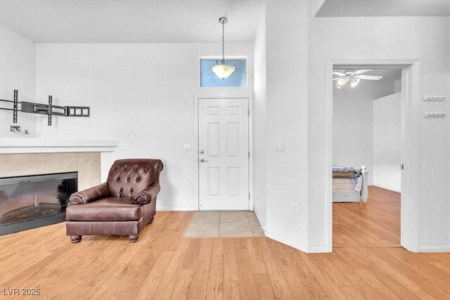 8985 S Durango Dr Unit 1110, Las Vegas, NV 89113 - foyer featuring wood finished floors, baseboards, ceiling fan, and a fireplace