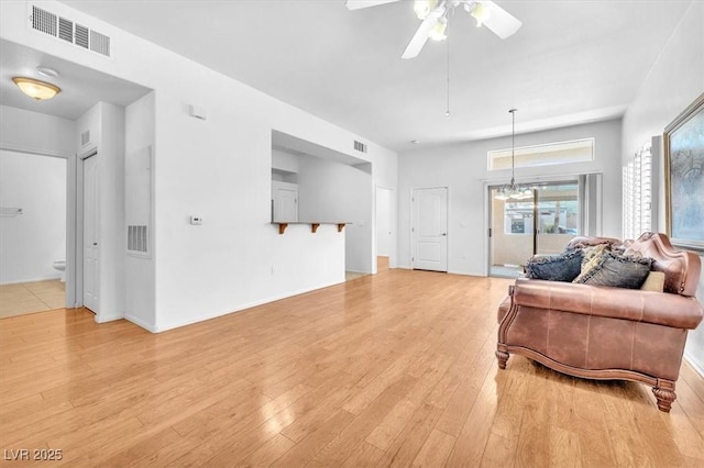 8985 S Durango Dr Unit 1110, Las Vegas, NV 89113 - living room featuring light wood finished floors, ceiling fan, a chandelier, and baseboards