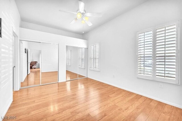 8985 S Durango Dr Unit 1110, Las Vegas, NV 89113 - unfurnished bedroom featuring multiple closets, light wood finished floors, baseboards, and ceiling fan