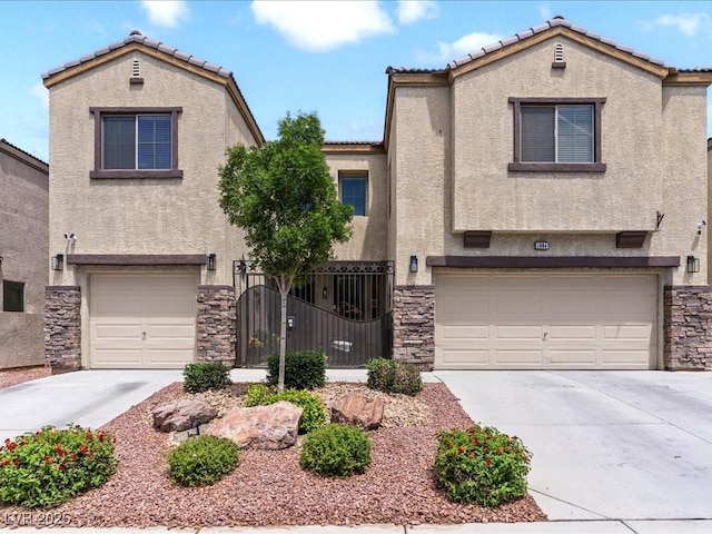 view of front facade featuring a garage, stone siding, stucco siding, and driveway