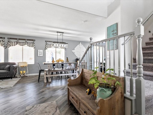living room with stairway, wood finished floors, and baseboards