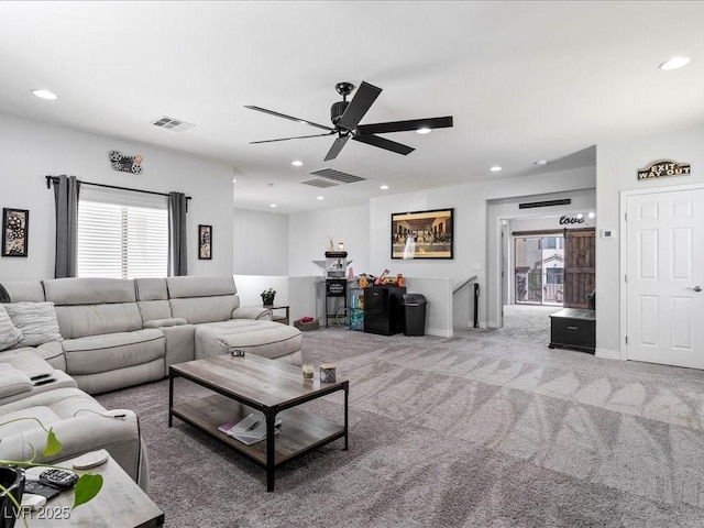 carpeted living area with healthy amount of natural light, ceiling fan, and recessed lighting