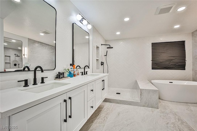 9340 W Washburn Rd, Las Vegas, NV 89149 - full bath with walk in shower, a soaking tub, double vanity, recessed lighting, and marble finish floors
