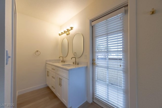 5040 Spencer St Unit D, Las Vegas, NV 89119 - full bath featuring wood finished floors, double vanity, and baseboards