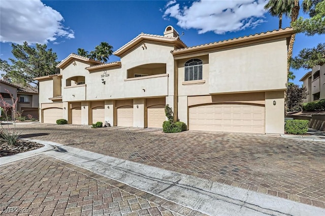 2050 W Warm Springs Rd Unit 3211, Henderson, NV 89014 - mediterranean / spanish-style house with an attached garage, stucco siding, decorative driveway, and a tile roof