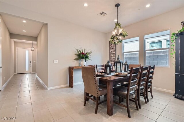 dining space with recessed lighting, baseboards, light tile patterned floors, and a chandelier