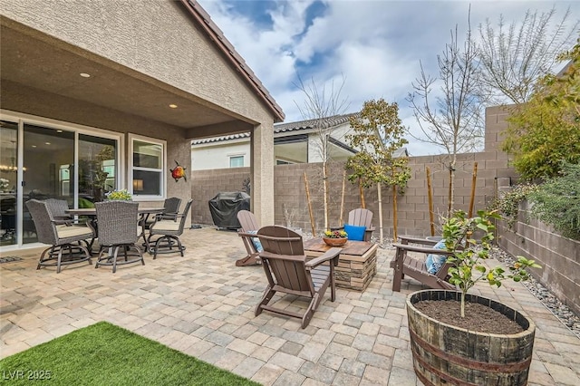 view of patio with a fenced backyard, grilling area, and outdoor dining space