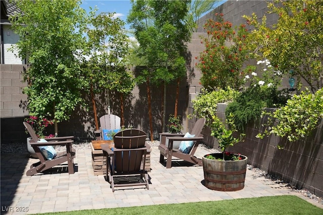 view of patio with a fenced backyard and an outdoor fire pit