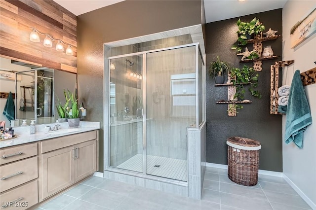 bathroom with a stall shower, tile patterned floors, and vanity