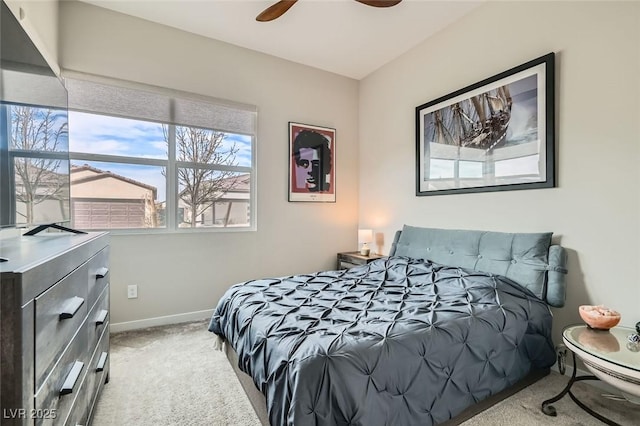 bedroom with light colored carpet and baseboards