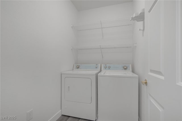 washroom featuring independent washer and dryer and baseboards