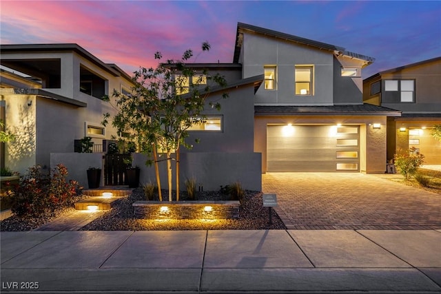 436 Crown Mesa Ave, Las Vegas, NV 89138 - contemporary house featuring decorative driveway, stucco siding, an attached garage, and fence