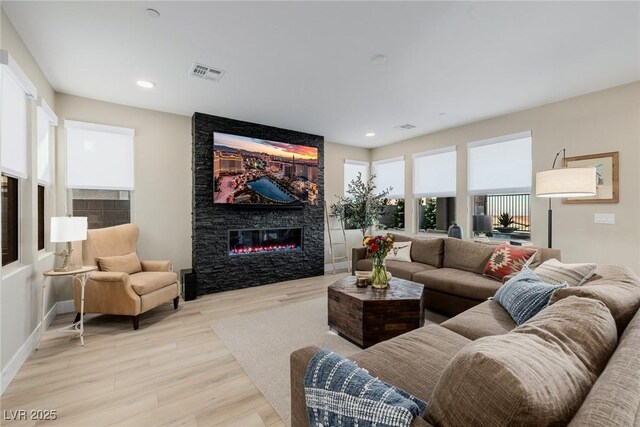 436 Crown Mesa Ave, Las Vegas, NV 89138 - living room with a fireplace, light wood finished floors, recessed lighting, and baseboards