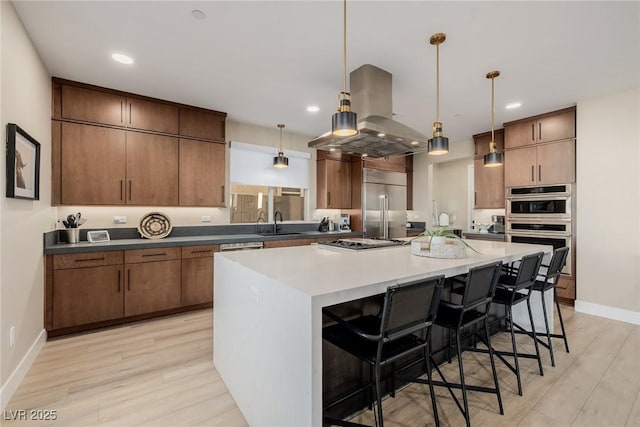 436 Crown Mesa Ave, Las Vegas, NV 89138 - kitchen featuring appliances with stainless steel finishes, a sink, island range hood, light wood-type flooring, and recessed lighting