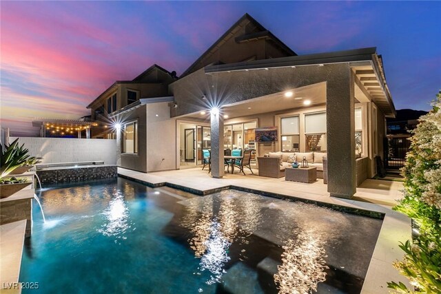 436 Crown Mesa Ave, Las Vegas, NV 89138 - back of house featuring outdoor lounge area, stucco siding, fence, and a pool with connected hot tub