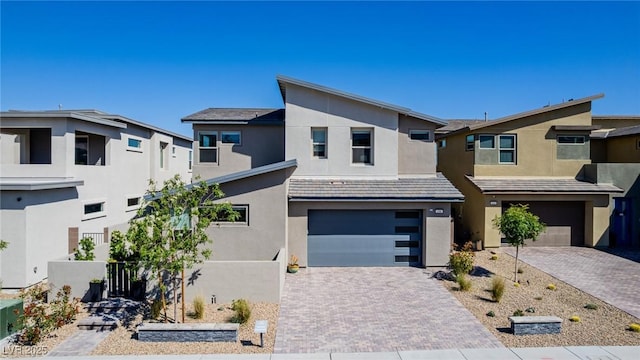 436 Crown Mesa Ave, Las Vegas, NV 89138 - view of front of home with an attached garage, stucco siding, and decorative driveway