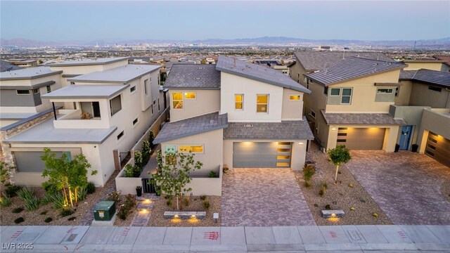 436 Crown Mesa Ave, Las Vegas, NV 89138 - view of front of home with stucco siding, an attached garage, decorative driveway, and a residential view
