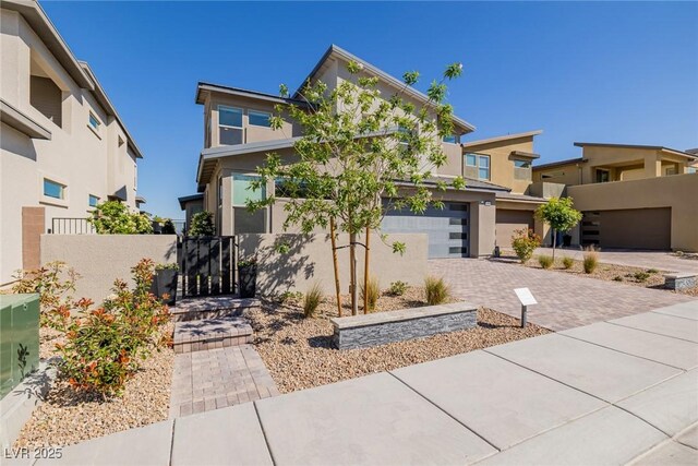 436 Crown Mesa Ave, Las Vegas, NV 89138 - view of front of property featuring an attached garage, stucco siding, driveway, and a gate