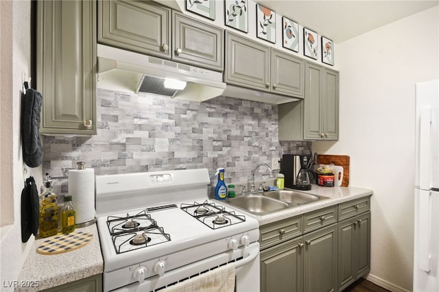 3982 Voxna St, Las Vegas, NV 89119 - kitchen featuring white appliances, under cabinet range hood, a sink, light countertops, and backsplash
