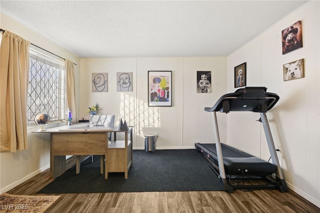 3982 Voxna St, Las Vegas, NV 89119 - workout room featuring wood finished floors, a textured ceiling, a decorative wall, and baseboards
