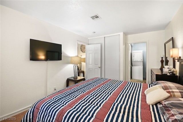 3982 Voxna St, Las Vegas, NV 89119 - bedroom with stacked washer / dryer, baseboards, a closet, and carpet floors