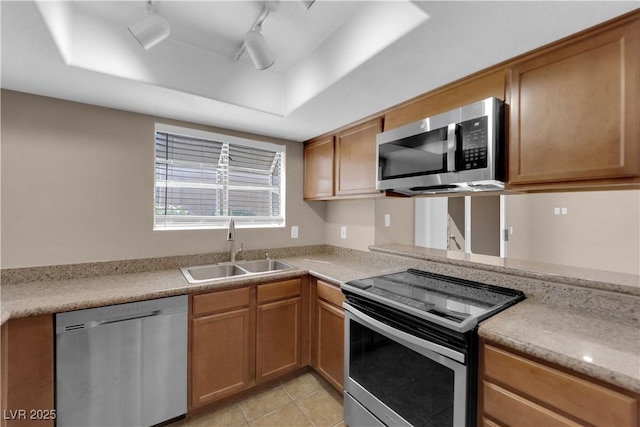 7200 Pirates Cove Rd Unit 1011, Las Vegas, NV 89145 - kitchen featuring stainless steel appliances, a sink, light countertops, and a tray ceiling