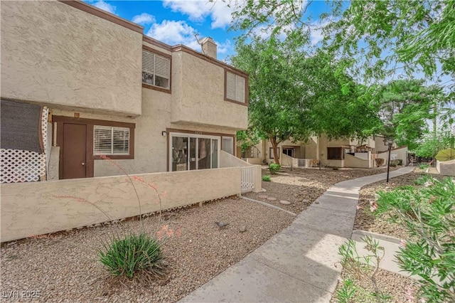 5029 Spencer St Unit D, Las Vegas, NV 89119 - back of property featuring stucco siding and a chimney