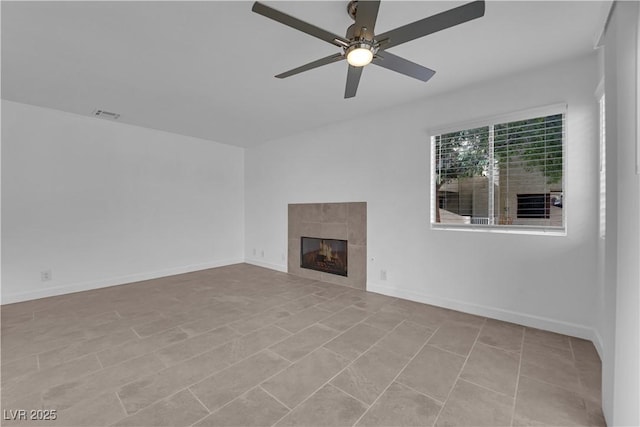 5029 Spencer St Unit D, Las Vegas, NV 89119 - unfurnished living room with ceiling fan, a tiled fireplace, and baseboards