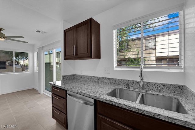 5029 Spencer St Unit D, Las Vegas, NV 89119 - kitchen featuring stainless steel dishwasher, a sink, a ceiling fan, dark brown cabinetry, and light stone countertops