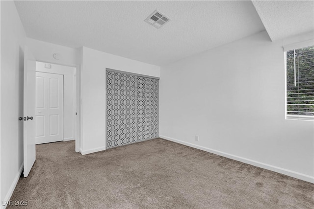 5029 Spencer St Unit D, Las Vegas, NV 89119 - unfurnished bedroom with a textured ceiling, carpet, and baseboards
