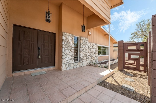 doorway to property with stone siding